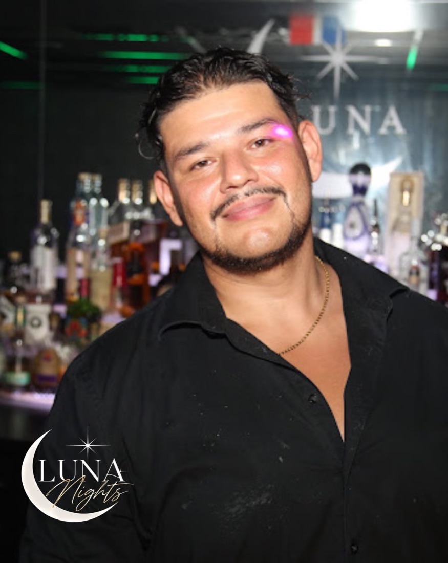 Guest in front of the back bar